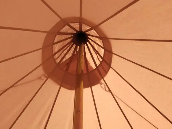 An opening top, designed so a wood stove flue can pass through the centre of the tent