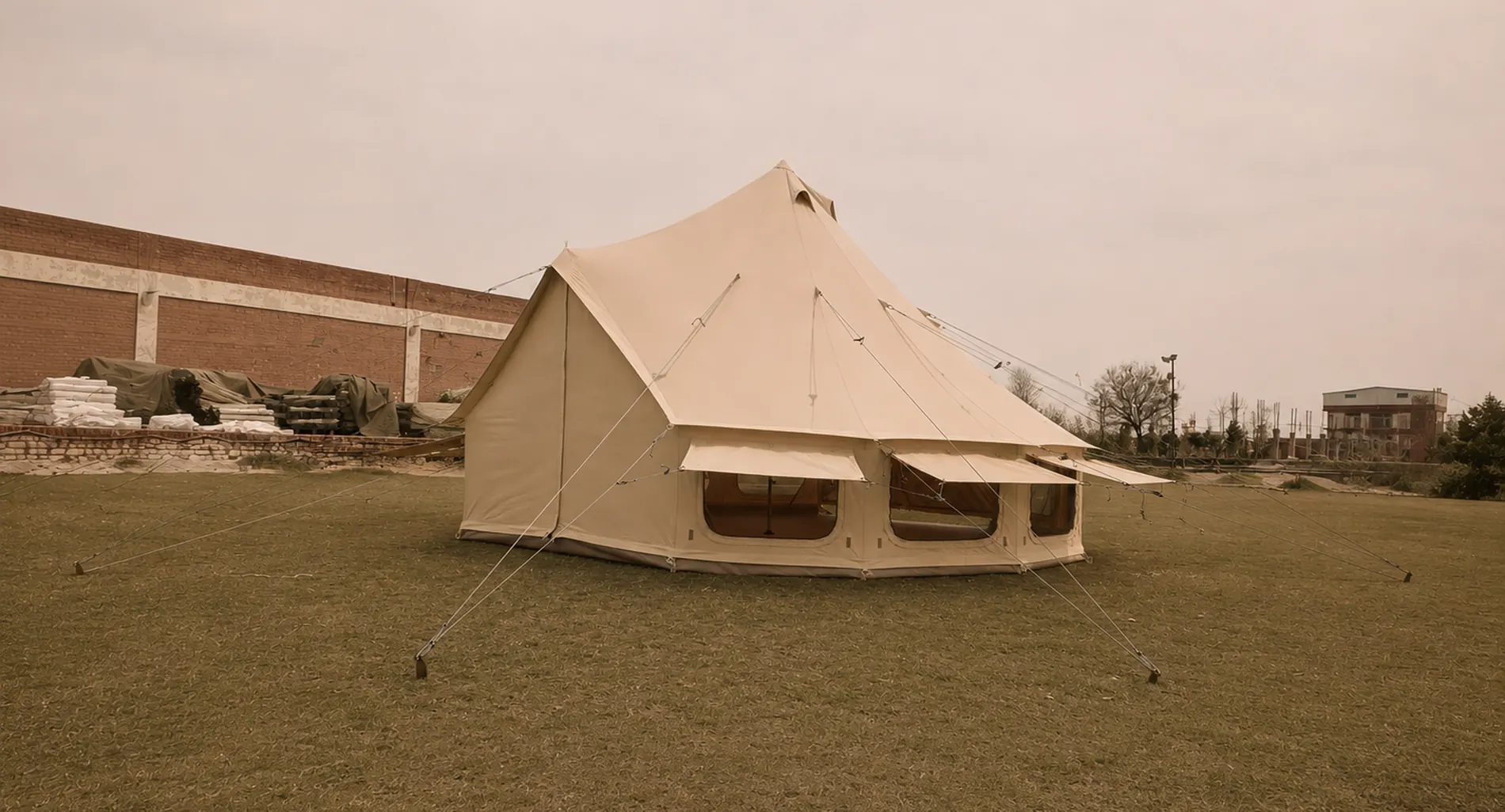 A bell tent pitched on grass under a clear sky