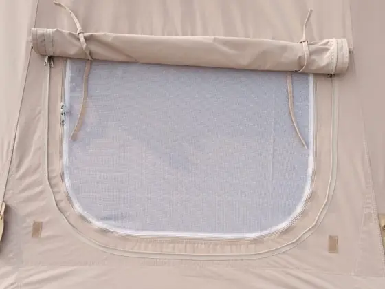 A window flap rolled up, with the mesh layer behind it